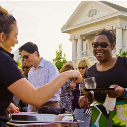 A Jubilee vendor serving food to an attendee.