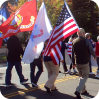 Hospice volunteers marching in a parade that celebrated veterans.